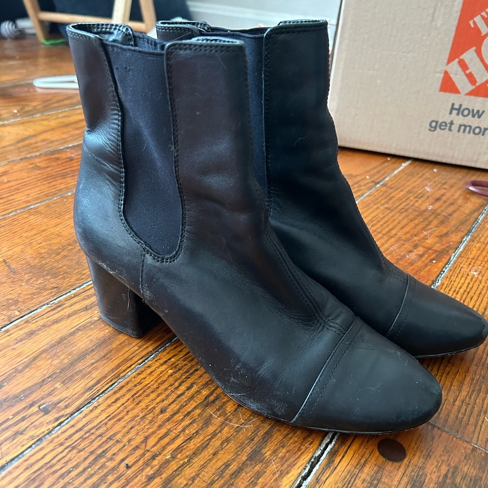 Black leather heeled boots.
